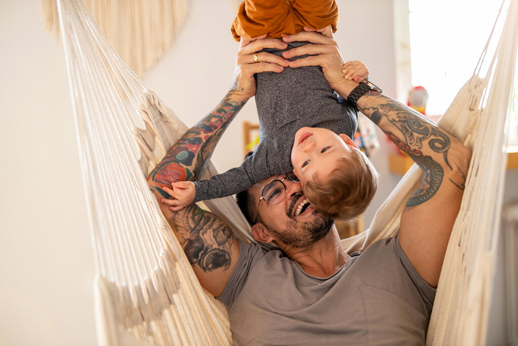 Father playing with his little son at home