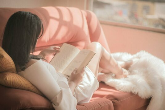 familie-lenin-estrada-GCpyNh39kOc-unsplash Frau lesend auf dem Sofa